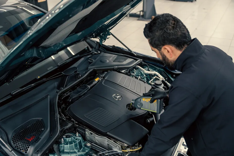 Mechanic inspecting a used car engine - vehicle history reports help Canadian buyers verify condition and accident history before purchase